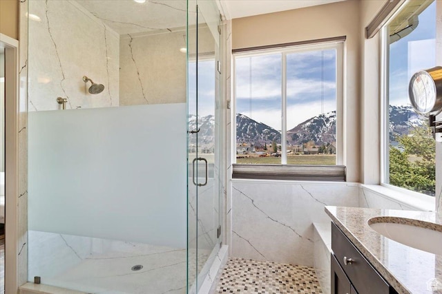 full bathroom with vanity, a mountain view, and a marble finish shower