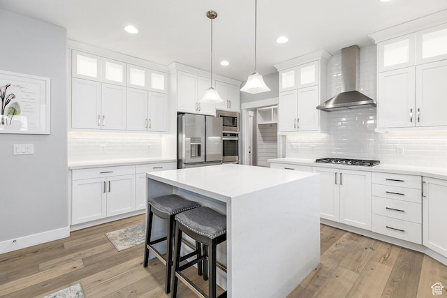 2913 S Puddle Ln, Saratoga Springs, UT 84045 - kitchen featuring decorative backsplash, appliances with stainless steel finishes, wall chimney range hood, a kitchen island, and a breakfast bar area