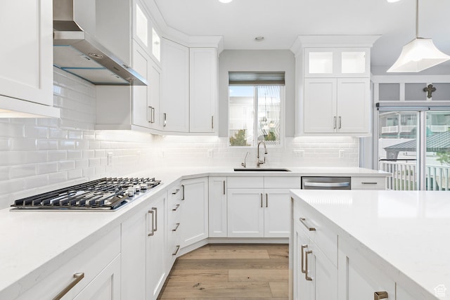 2913 S Puddle Ln, Saratoga Springs, UT 84045 - kitchen with light wood finished floors, a sink, wall chimney exhaust hood, appliances with stainless steel finishes, and white cabinetry