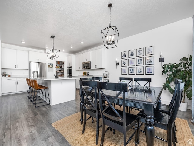 667 S Meade St, Mapleton, UT 84664 - dining space with a chandelier, dark wood-type flooring, recessed lighting, and a textured ceiling
