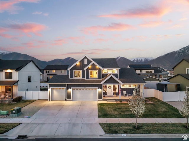 667 S Meade St, Mapleton, UT 84664 - view of front of house with concrete driveway, a mountain view, board and batten siding, a garage, and fence