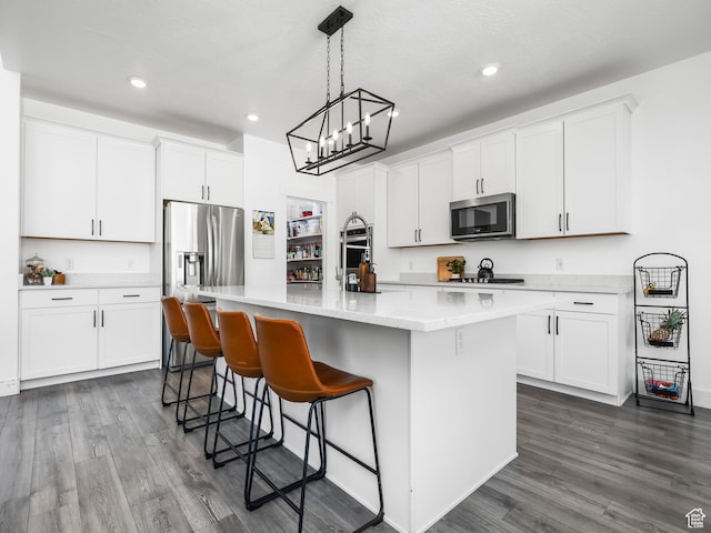 667 S Meade St, Mapleton, UT 84664 - kitchen with white cabinetry, light countertops, a kitchen island with sink, dark wood finished floors, and appliances with stainless steel finishes