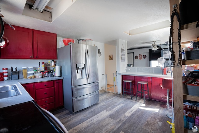 190 S Broadway St, Tooele, UT 84074 - kitchen with light countertops, stainless steel refrigerator with ice dispenser, ceiling fan, a sink, and wood finished floors