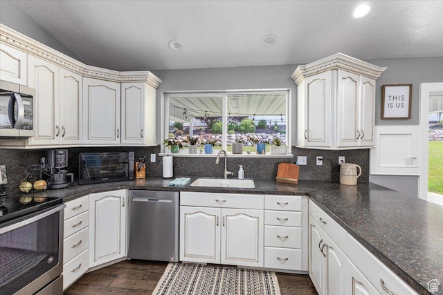 kitchen with a sink, tasteful backsplash, a toaster, and stainless steel appliances