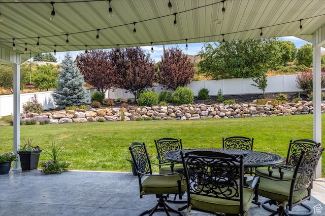 view of patio with outdoor dining space and fence