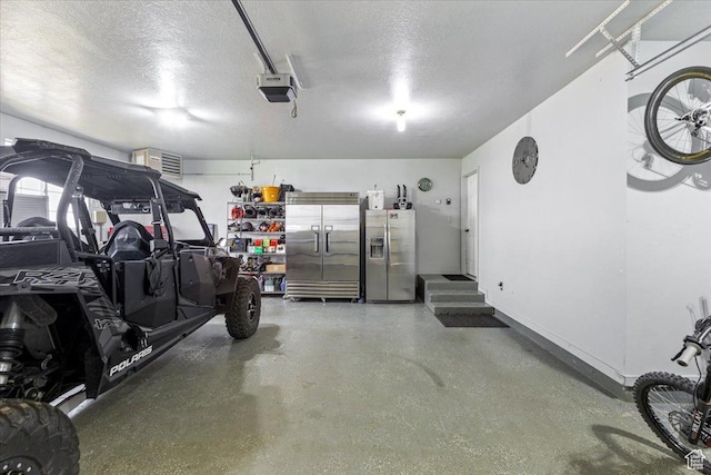 garage featuring stainless steel fridge with ice dispenser, built in refrigerator, baseboards, and a garage door opener