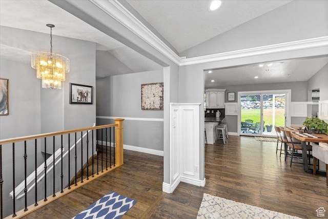 hall featuring an inviting chandelier, vaulted ceiling, recessed lighting, an upstairs landing, and dark wood-style floors