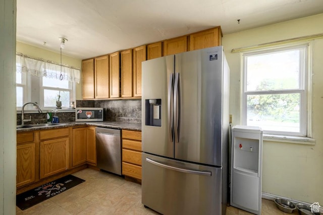 12640 S 1565 E, Draper, UT 84020 - kitchen with brown cabinetry, appliances with stainless steel finishes, a sink, and dark countertops