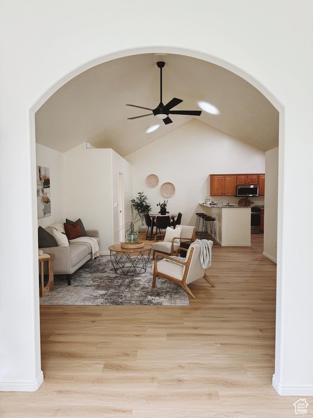 374 N 1100 E Unit F3, Lehi, UT 84043 - living room featuring lofted ceiling, arched walkways, light wood-type flooring, and ceiling fan