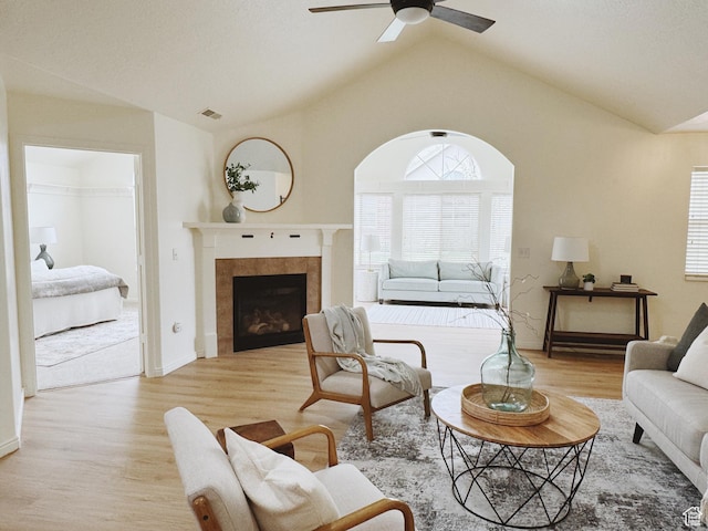 374 N 1100 E Unit F3, Lehi, UT 84043 - living area with vaulted ceiling, ceiling fan, a tile fireplace, light wood finished floors, and visible vents
