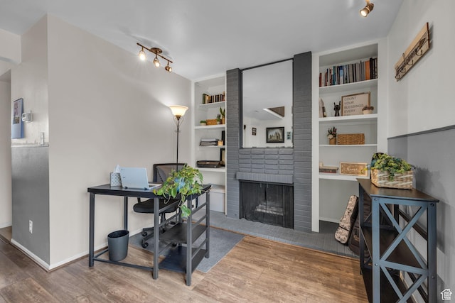 490 E Tonalea Dr, Murray, UT 84107 - office space featuring built in features, track lighting, wood finished floors, a brick fireplace, and baseboards