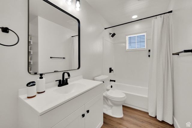bathroom featuring shower / bath combo with shower curtain, vanity, toilet, and wood finished floors