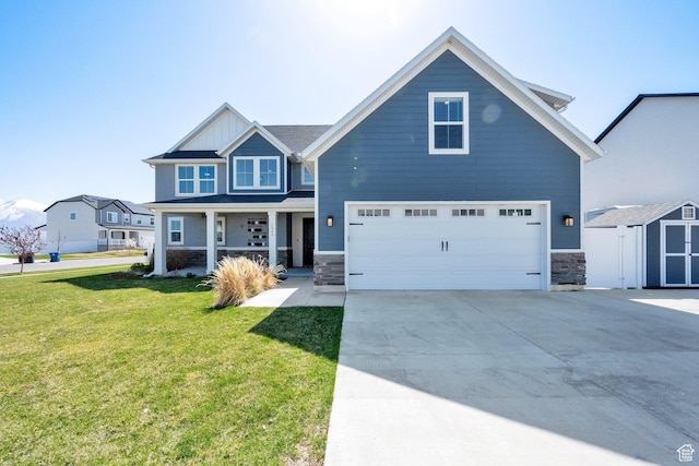 craftsman-style home with a porch, stone siding, a front lawn, an attached garage, and concrete driveway