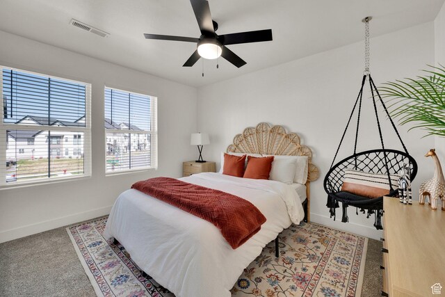 bedroom featuring visible vents, baseboards, multiple windows, and carpet flooring