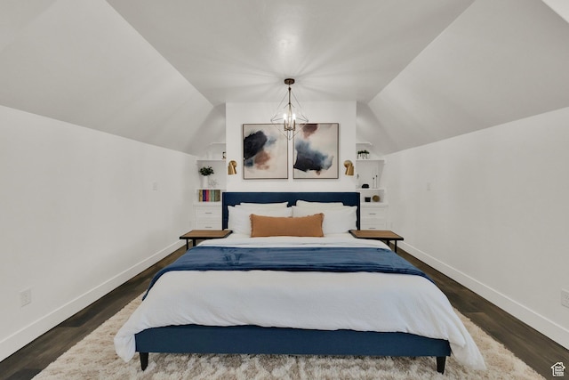 bedroom with wood finished floors, baseboards, and lofted ceiling
