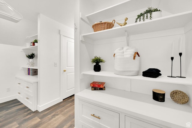 mudroom featuring baseboards and dark wood-style floors