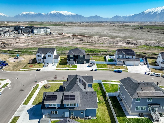 birds eye view of property with a mountain view and a residential view