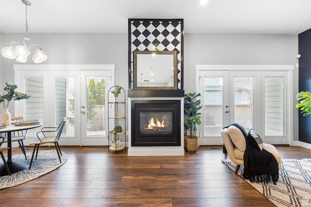 10609 S Kestrel Rise Rd, South Jordan, UT 84009 - sitting room with dark wood-style flooring, french doors, a large fireplace, and an inviting chandelier
