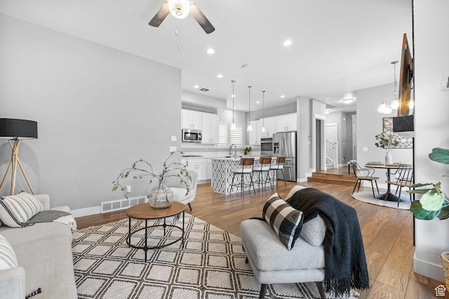 10609 S Kestrel Rise Rd, South Jordan, UT 84009 - living room featuring light wood-type flooring, a ceiling fan, visible vents, recessed lighting, and baseboards