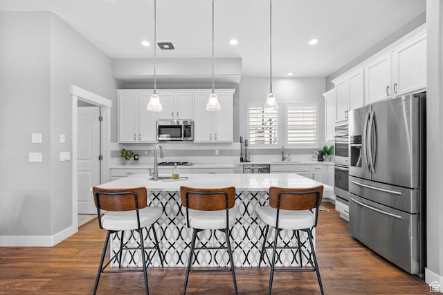 10609 S Kestrel Rise Rd, South Jordan, UT 84009 - kitchen featuring light countertops, a kitchen bar, decorative backsplash, stainless steel appliances, and a sink