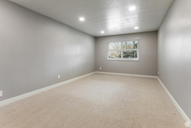 2710 S Highland Dr Unit 11, Salt Lake City, UT 84106 - unfurnished room featuring baseboards, recessed lighting, and light carpet