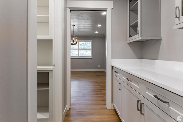 2710 S Highland Dr Unit 11, Salt Lake City, UT 84106 - hall with baseboards, ornamental molding, a chandelier, recessed lighting, and light wood-style flooring