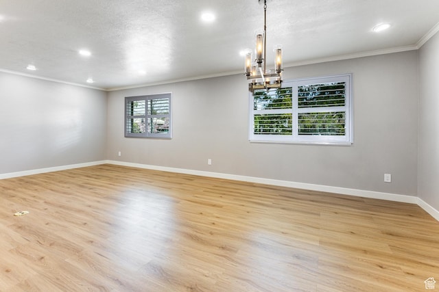2710 S Highland Dr Unit 11, Salt Lake City, UT 84106 - empty room featuring light wood-style flooring, an inviting chandelier, and baseboards