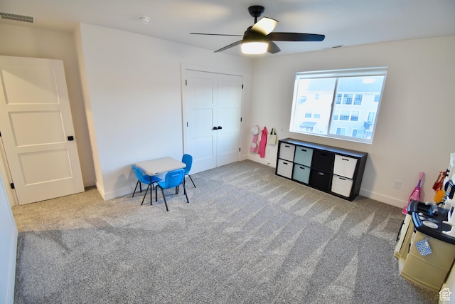 playroom with carpet, visible vents, baseboards, and ceiling fan