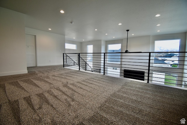 carpeted empty room featuring baseboards and recessed lighting