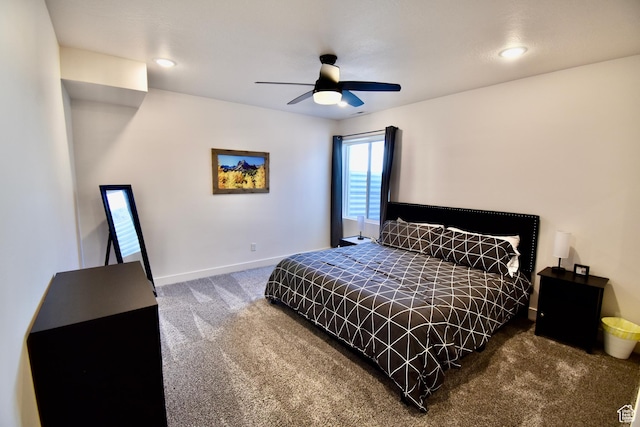 carpeted bedroom with ceiling fan and baseboards