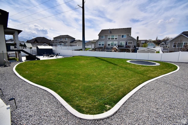 view of yard with a patio area, a residential view, and a fenced backyard