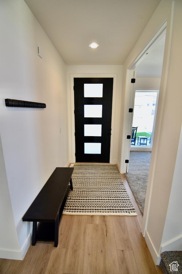 foyer with wood finished floors, baseboards, and recessed lighting