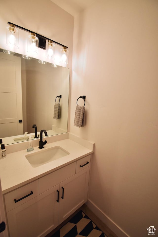 bathroom featuring baseboards and vanity