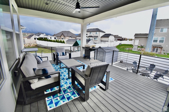 wooden terrace featuring a residential view, an outdoor living space, a grill, and a ceiling fan