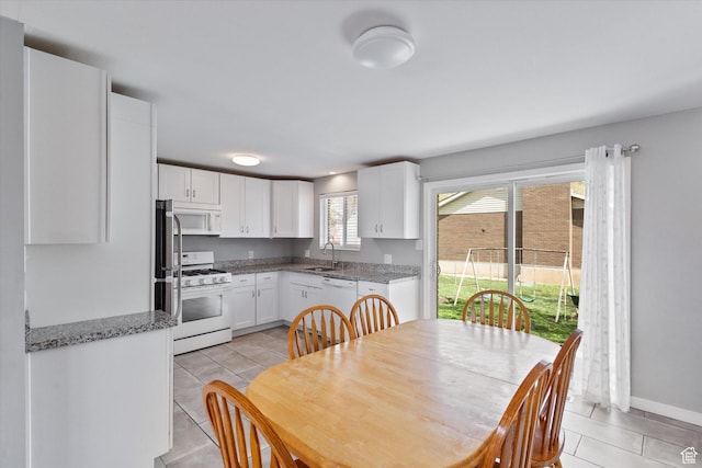 1322 N Main St, Centerville, UT 84014 - dining space featuring light tile patterned floors and baseboards