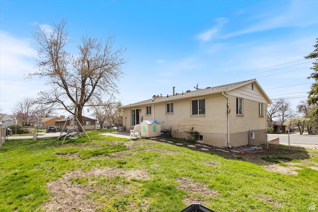 1322 N Main St, Centerville, UT 84014 - rear view of property with brick siding, fence, a lawn, and a patio area