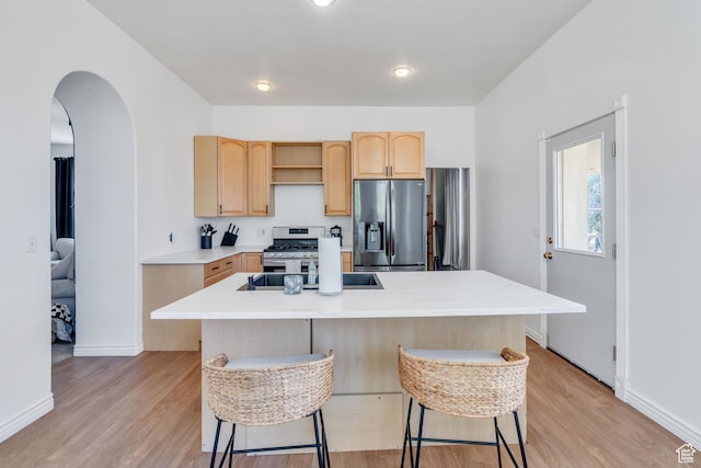 105 W 600 S, Manti, UT 84642 - kitchen featuring stainless steel appliances, light wood-style flooring, light brown cabinets, and a breakfast bar area