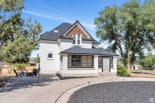 105 W 600 S, Manti, UT 84642 - view of front of house with brick siding, a shingled roof, a fire pit, and a patio area