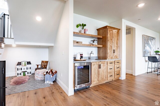 1285 N Oquirrh Mountain Dr, Heber City, UT 84032 - bar with light wood-style floors, indoor wet bar, baseboards, visible vents, and wine cooler