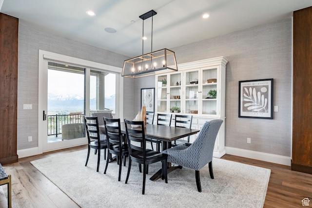 1285 N Oquirrh Mountain Dr, Heber City, UT 84032 - dining space with wallpapered walls, wood finished floors, a chandelier, and baseboards