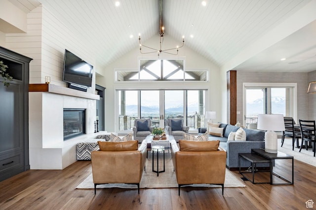 1285 N Oquirrh Mountain Dr, Heber City, UT 84032 - living room featuring beam ceiling, wood finished floors, a healthy amount of sunlight, and a glass covered fireplace
