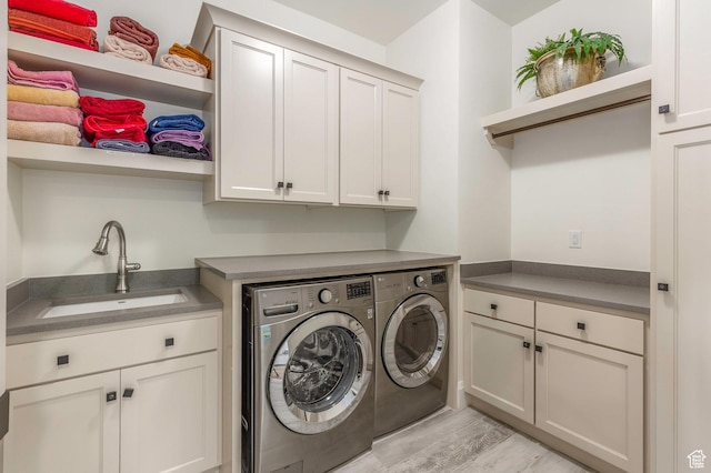 1285 N Oquirrh Mountain Dr, Heber City, UT 84032 - laundry room featuring cabinet space, separate washer and dryer, light wood finished floors, and a sink