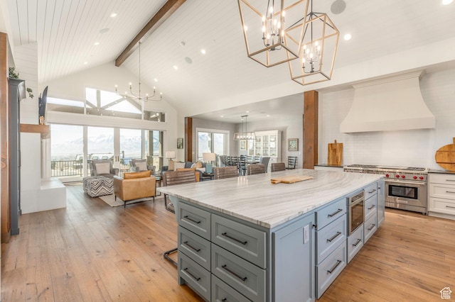 1285 N Oquirrh Mountain Dr, Heber City, UT 84032 - kitchen featuring designer stove, a notable chandelier, custom range hood, gray cabinetry, and open floor plan