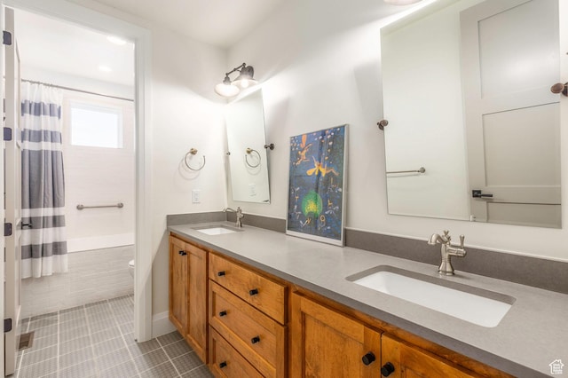 1285 N Oquirrh Mountain Dr, Heber City, UT 84032 - bathroom featuring tile patterned floors, toilet, double vanity, and a sink