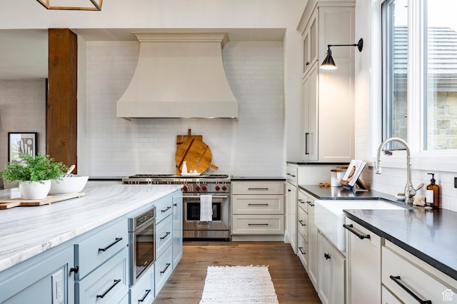 1285 N Oquirrh Mountain Dr, Heber City, UT 84032 - kitchen featuring premium stove, a sink, custom range hood, and decorative backsplash