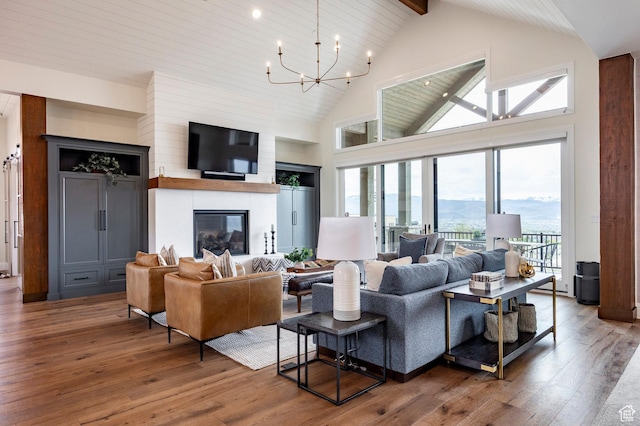 1285 N Oquirrh Mountain Dr, Heber City, UT 84032 - living area with high vaulted ceiling, a chandelier, hardwood / wood-style floors, and a healthy amount of sunlight