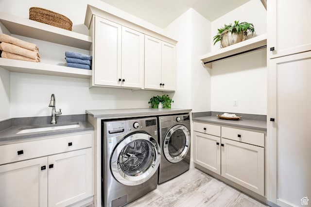 1285 N Oquirrh Mountain Dr, Heber City, UT 84032 - clothes washing area featuring cabinet space, washing machine and clothes dryer, light wood finished floors, and a sink