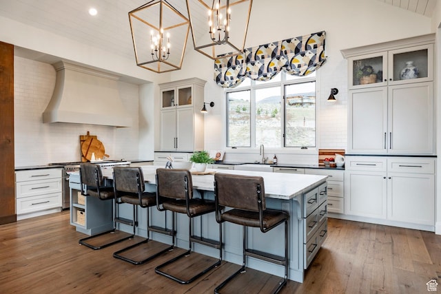 1285 N Oquirrh Mountain Dr, Heber City, UT 84032 - kitchen with a center island, a breakfast bar area, premium range hood, and backsplash
