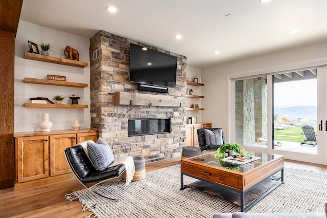 1285 N Oquirrh Mountain Dr, Heber City, UT 84032 - living room with recessed lighting, a stone fireplace, and light wood-style flooring