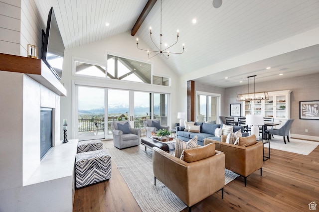 1285 N Oquirrh Mountain Dr, Heber City, UT 84032 - living area featuring beamed ceiling, an inviting chandelier, a glass covered fireplace, wood finished floors, and high vaulted ceiling